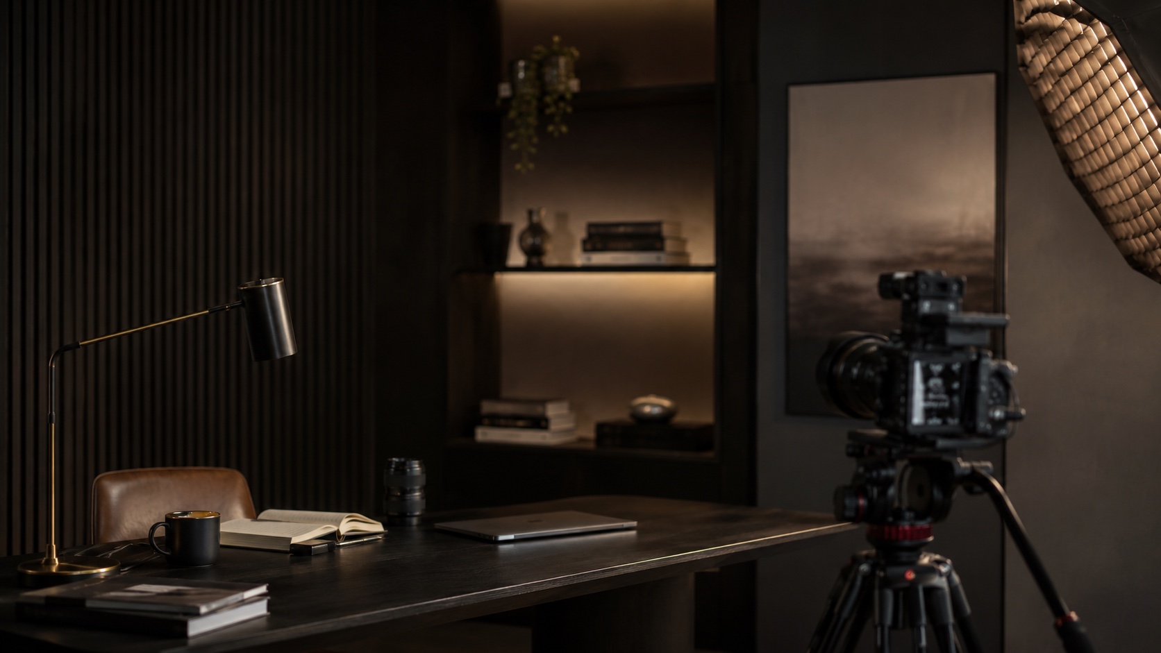 A cinematic content studio desk with a camera, lighting, and workspace tools.